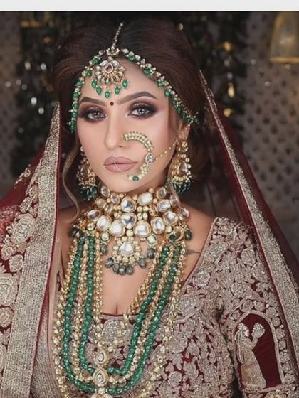 A magnificent, multi-layered Kundan and emerald bead jewellery set. This is the epitome of a royal bridal look, available for rent.
