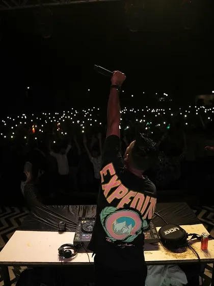 On the mic, connecting with the students at IIT Indore. The sea of phone lights creates a magical atmosphere.