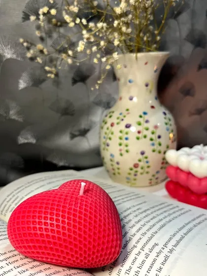 Here you can see the detailed texture of our red heart candle. We designed it to sit perfectly on a stack of books or a bedside table, adding a pop of color and a touch of romance to your personal space.