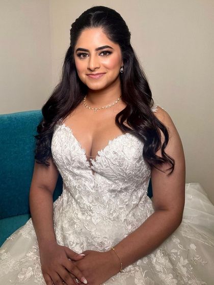 The full look is one of modern elegance. The simple yet flawless makeup pairs perfectly with her beautiful lace wedding dress.