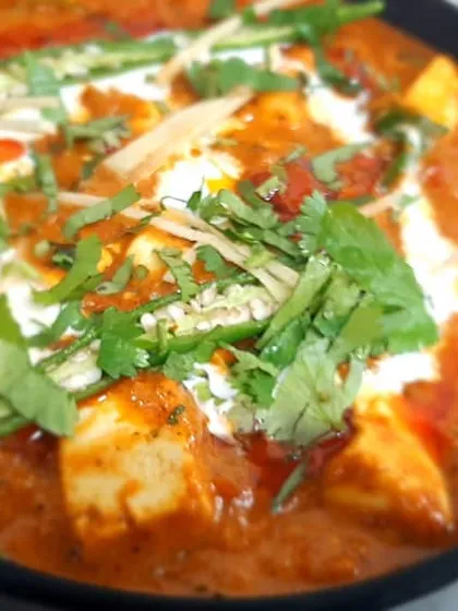 Our Paneer Butter Masala is a crowd favourite. We use soft paneer cubes in a rich, creamy tomato gravy, garnished with fresh coriander and ginger for that perfect finish.