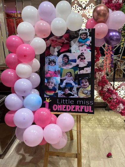 A "Little Miss ONEderful" photo collage board, a lovely personal touch for a first birthday.