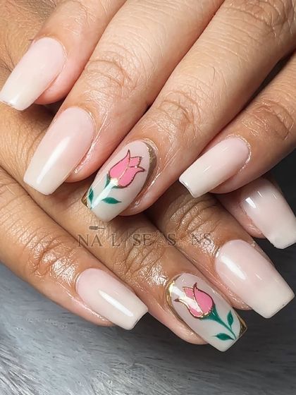 A delicate and chic design with a soft nude base and hand-painted pink tulips with a chrome outline.