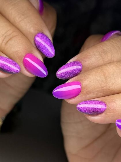A vibrant and playful manicure featuring a mix of purple cat-eye and a bright pink-to-purple ombré.
