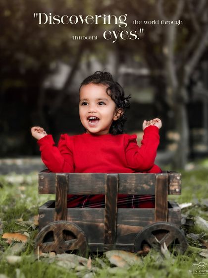 Discovering the world through innocent eyes. A girl in a bright red sweater laughs with joy in her wooden wagon.