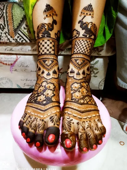Bridal mehndi isn't just for hands. We create stunning, intricate designs for feet that complement your overall bridal look, featuring traditional motifs like elephants and detailed floral patterns.