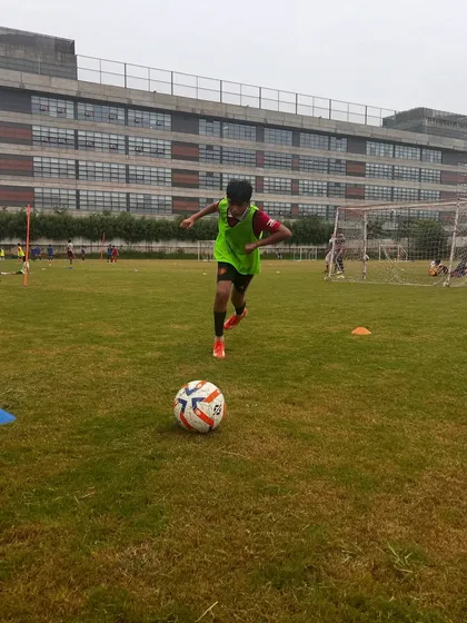 A young athlete running with the ball, building both speed and ball control.