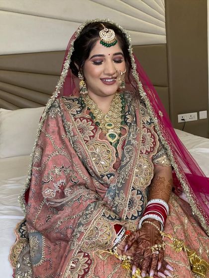 A candid moment captured, showing off her beautiful smile and the flawless finish of her makeup.