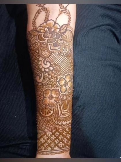 A lovely bridal arm piece featuring a basket of flowers motif. This is a unique element that can be incorporated into a traditional design.