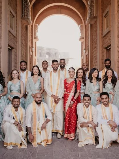 The bride and groom with their wedding party during the Ganesh Puja, a beautiful blend of cultures and traditions.