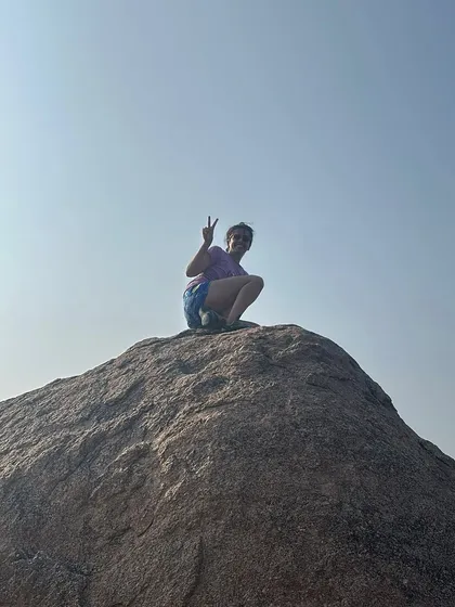A victory sign from the top of a boulder. Each climb, big or small, is a personal victory and a lesson in what we are capable of.