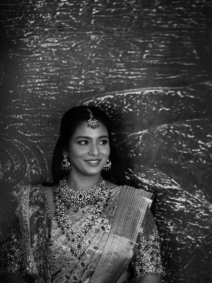 A classic black and white portrait of Sruthi. This timeless photo emphasizes her beautiful smile and the elegance of her reception attire.