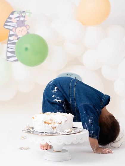 A hilarious "yoga pose" to burn off the cake calories. Toddlers are so unpredictable, and this candid moment of him diving headfirst into the cake was too funny not to capture.