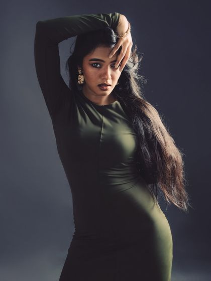 A strong pose with a focus on the model's direct gaze and flowing hair.