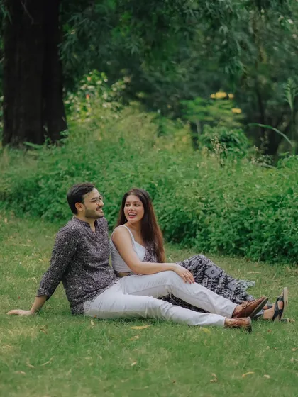 A relaxed moment for Jayashree and Anand, sitting together on the grass. This photo captures the easy comfort and happiness of their relationship.