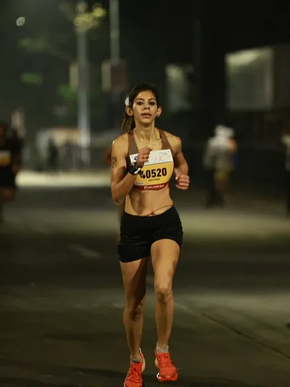 A night shot from a race, focused and in the zone. Running under the lights has a different energy, but the goal is always the same: give it your all.