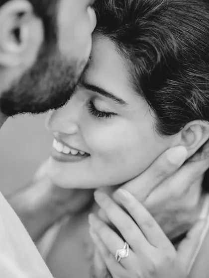An intimate black and white close-up of Dylan and Maclene. This portrait focuses purely on the couple's emotion and connection, highlighting the engagement ring as a subtle detail.