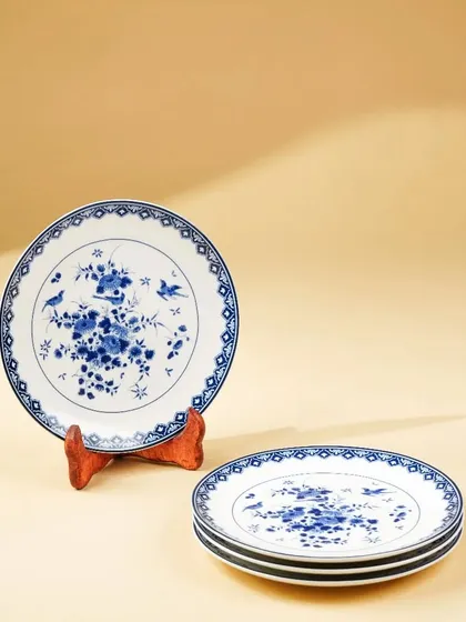 A set of beautifully designed ceramic plates, with a focus on the intricate blue-and-white pattern.