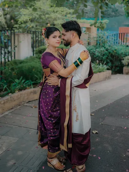 A classic portrait pose with the couple embracing. The direct eye contact from the bride creates a strong connection with the viewer, showcasing her confidence and beauty.