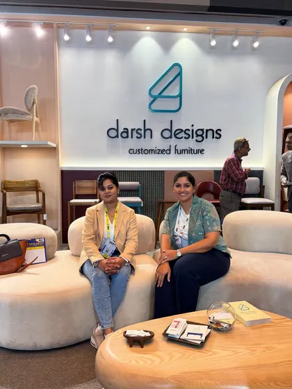 Two visitors relaxing on the custom sofa at our exhibition booth. My goal is to create furniture that is not only beautiful but also comfortable and inviting.