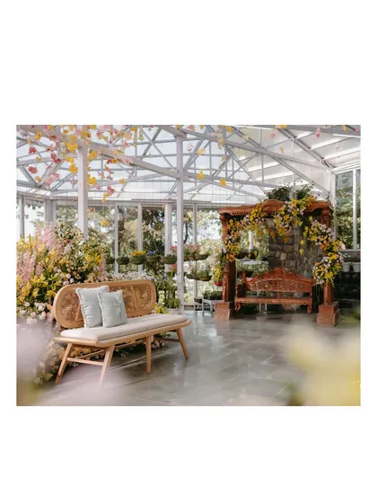 A wider view of the Haldi setup in the Mussoorie greenhouse. This shot shows the relationship between the main seating bench and the decorated swing, creating two distinct yet harmonious focal points.