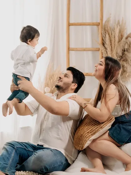 The pure delight on a child's face being lifted by his father. This studio shot is full of movement and happiness, a perfect memory of this playful stage.