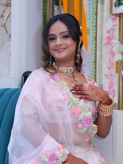 A beautiful engagement look. I created a romantic style with a soft pink smokey eye and a gentle, wavy updo to complement her floral lehenga.