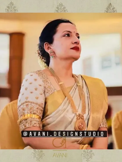 An elegant off-white blouse with gold embroidery on the sleeves and delicate butti work on the body. This piece is a timeless addition to any saree collection.