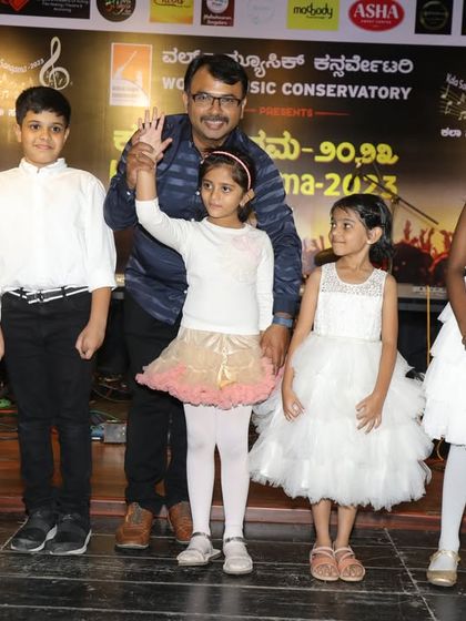 A teacher celebrates with his young student on stage. These moments of encouragement are a huge part of our teaching philosophy.