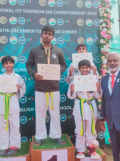 Students on the podium at the 19th National Championship, a proud moment for the team.