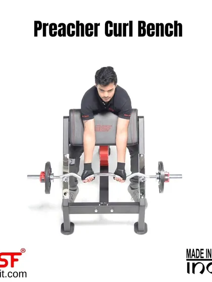 A user demonstrating a bicep curl on our Preacher Curl Bench. This bench is designed to completely isolate the biceps for a focused and intense arm workout.