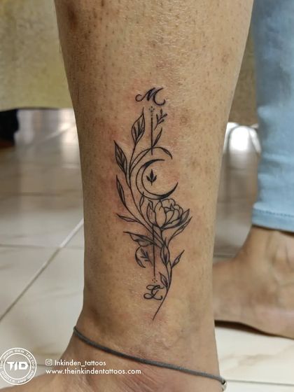 A beautiful floral tattoo with initials 'M' and 'L' integrated into the design.