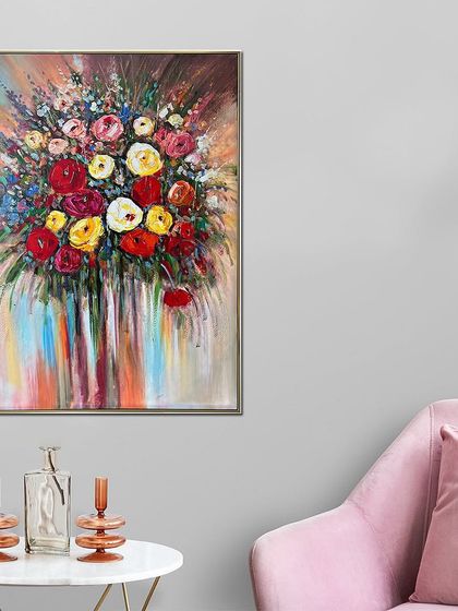 A beautiful bouquet of flowers bursts from the canvas in this hand-painted piece. The vibrant reds, yellows, and pinks are applied with thick, expressive strokes, creating a joyful and energetic floral artwork.