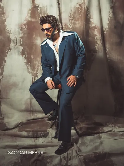 Arjun Kapoor styled in a retro-inspired blue suit. The full look, with its wide collar and relaxed fit, is a modern interpretation of a classic era, designed for confident self-expression.