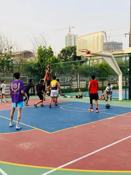 A wide shot of the court during a scrimmage, showing players moving and communicating.
