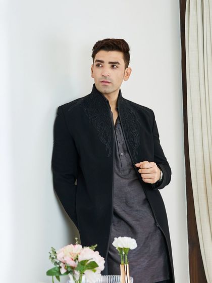 The full ensemble showcases the fusion of a traditional kurta length with a modern, structured jacket. This is for the man who isn't afraid to make a style statement.
