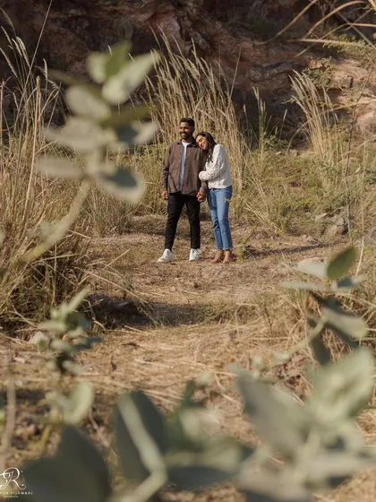 Using foliage in the foreground to frame the couple adds an artistic, documentary feel to this photo. It makes it feel like we are peeking in on a private, intimate moment.