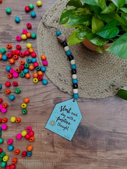 Our 'Start Each Day with a Positive Thought' beaded hut is a great way to begin your day. This hand-doodled piece with colorful beads is a small but meaningful addition to your home decor.
