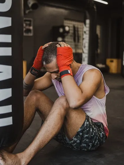A fighter takes a moment to recover after a grueling set of core exercises. The grind is real.