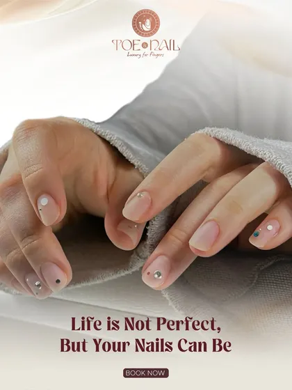 Even simple nail art can make a big impact. This minimalist design features a natural base with delicate dots and strategically placed rhinestones for a touch of sparkle.