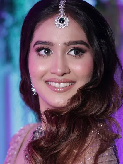 This portrait showcases the flawless base and the soft glam of the reception makeup. The look is designed to be timeless and elegant, perfect for the final celebration.