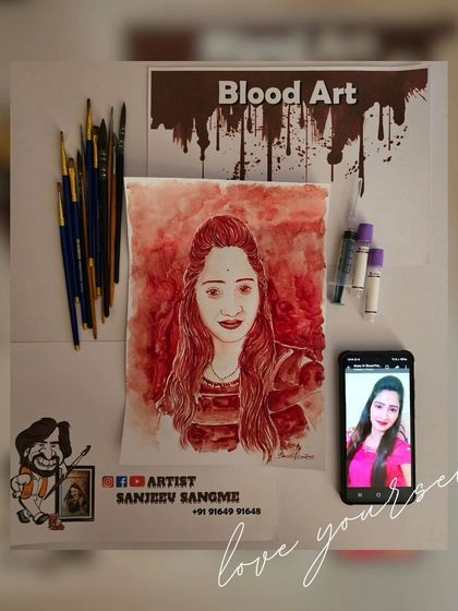 This image shows a finished blood portrait with the reference photo and my art supplies. It gives a complete picture of the creative process from start to finish.