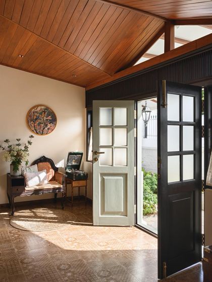 The entrance to the Mount Pleasant Villa, where restored panelled doors and patterned floor tiles welcome visitors into a space that honors its 1940s origins.