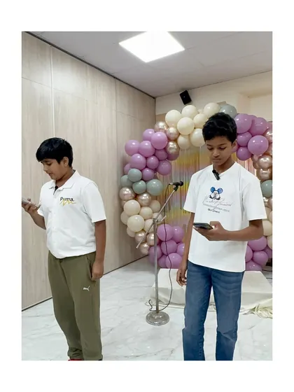Two students practice their public speaking piece together, learning to coordinate and support each other.