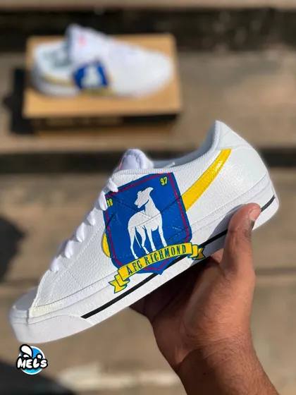 A hand-held shot showcasing the vibrant blue and yellow of the hand-painted AFC Richmond crest.