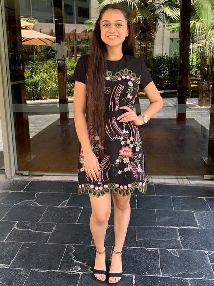 This dress is a masterclass in using detail to flatter your shape. The vibrant thread embroidery on a black base creates a beautiful silhouette and cinches at the waist, enhancing the body's natural curves without any extra effort.