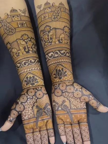 This design is like a storybook on the arms, with elephants, birds, and paisley motifs. The palms feature parrots, symbolizing love and passion.