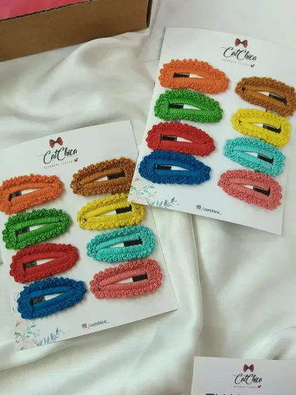 Two full sets of our colorful crochet barrettes, ready to be packaged. They are a simple and fun accessory for girls of all ages.