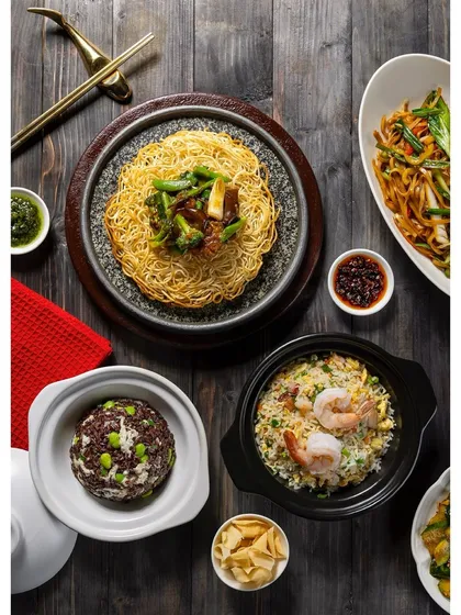 A flat lay of various rice and noodle dishes, showcasing the variety available on an Asian menu.