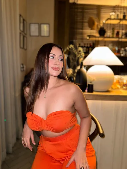 A candid shot in the bright orange two-piece outfit.